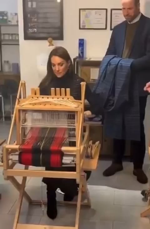 William holding Catherine's coat while she weaves