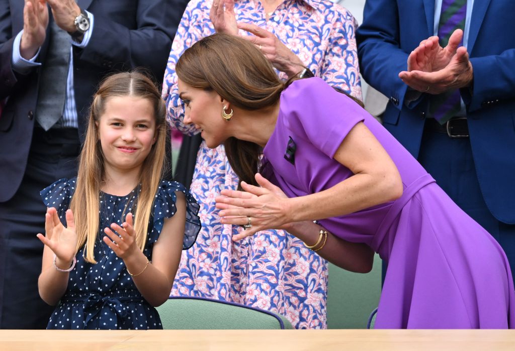 Princess kate in royal box leaning in to talk to princess charlotte