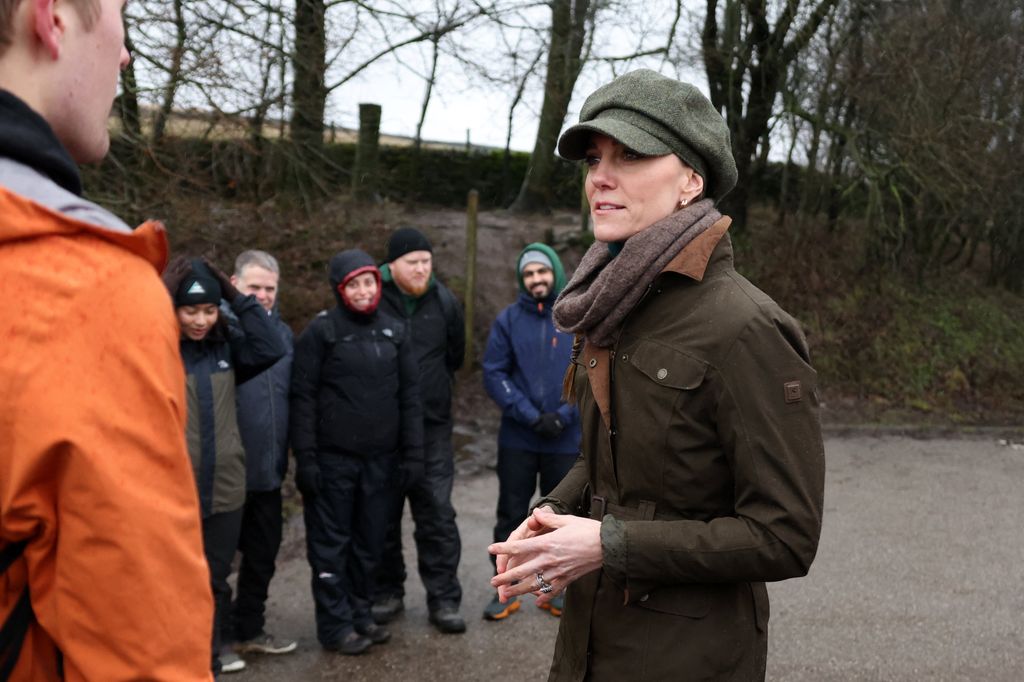 Britain's Catherine, Princess of Wales, listens during a guided walk in the Peak District with members of the Mind Over Mountains charity, near Curbar, northern England on January 27, 2026