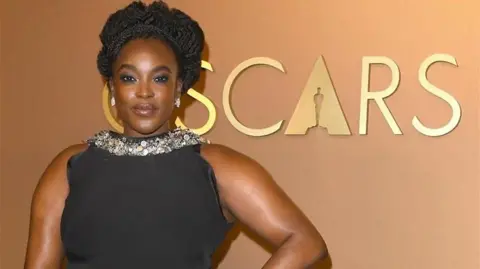 Getty Images Wunmi Mosaku is pictured in a yellow dress and diamond earrings while attending the 83rd Golden Globes awards at The Beverly Hilton in Beverly Hills, Los Angeles. 