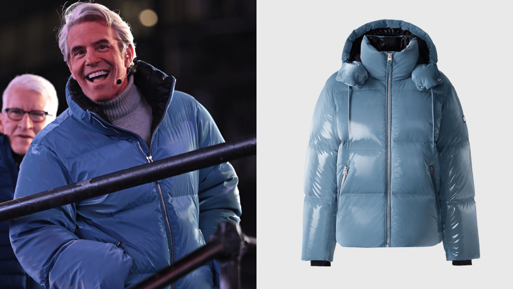 andy cohen smiling as he hosts cnn's new year's eve special this year, wearing blue glossy coat; said blue glossy coat from label mackage over light background