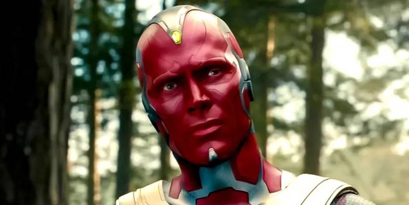 Paul Bettany as Vision in Avengers Age of Ultron looking to the side in a forest.