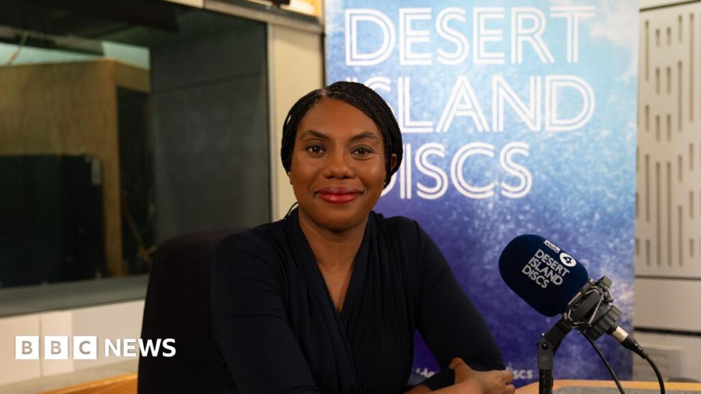 Kemi Badenoch, dressed in black, sitting in the Desert Island Discs studio
