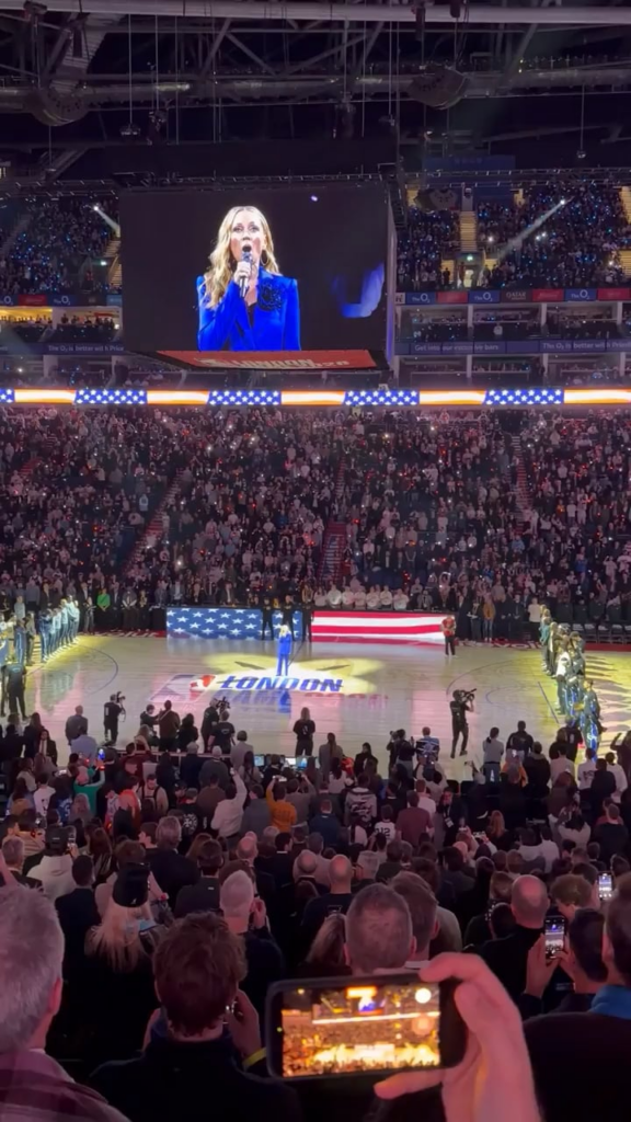 Crowd erupts in cheers as one fan shouts "Leave Greenland Alone!" during U.S. anthem at London NBA game.
