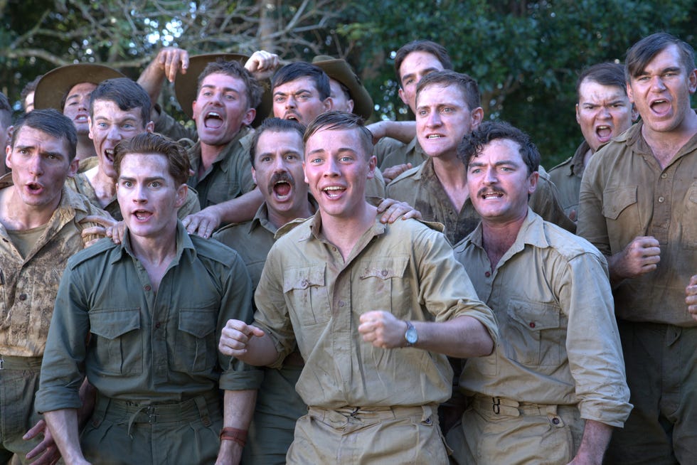 group of individuals wearing military uniforms with a focus on camaraderie