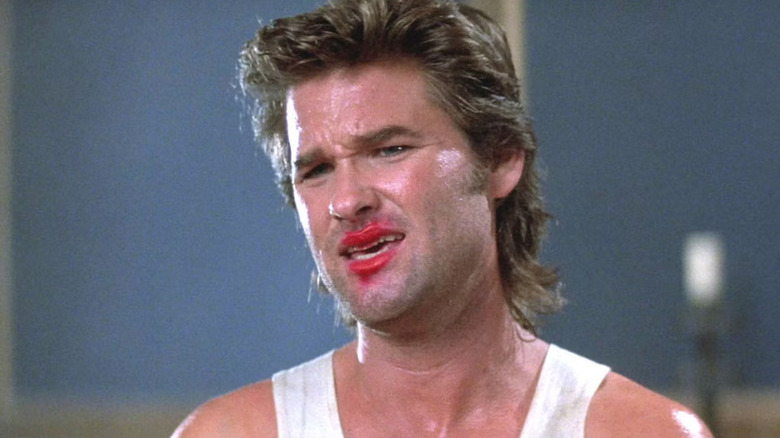 Jack Burton (Kurt Russell) looks incredulous with lipstick smeared on his face in Big Trouble in Little China