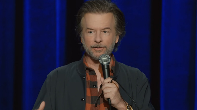 David Spade performing stand-up in his special Dandelion