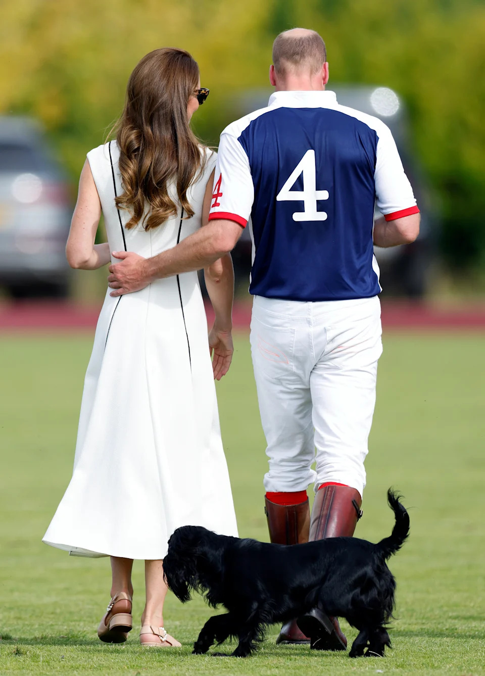 Prince William and Kate Middleton from behind, walking with their dog Orla