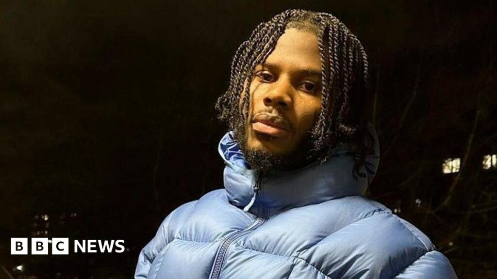 Jim Legxacy pictured outdoors at night in a light blue puffa jacket