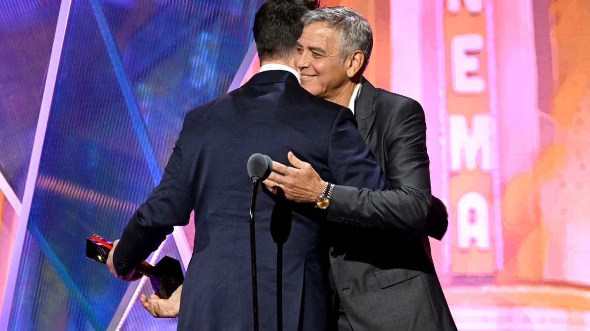 Noah Wyle and George Clooney hugging
