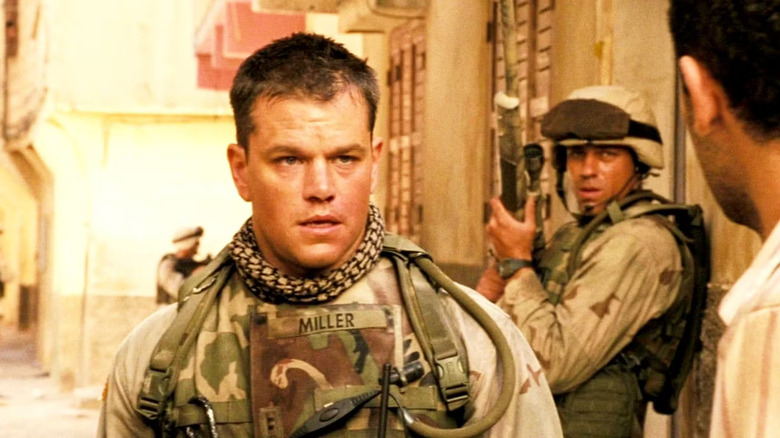 Roy Miller talks to an Iraqi citizen on the street in 