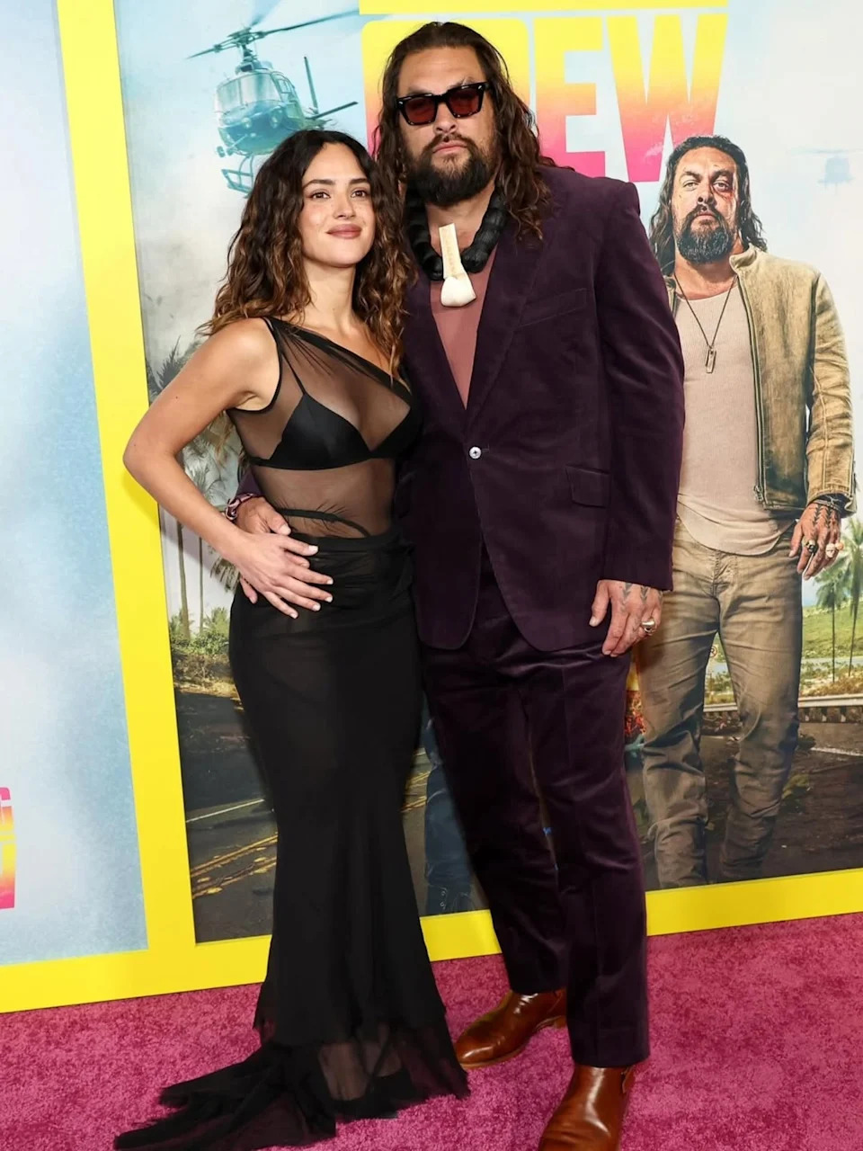 Adria Arjona and Jason Momoa pose for photographers at a recent red carpet event.