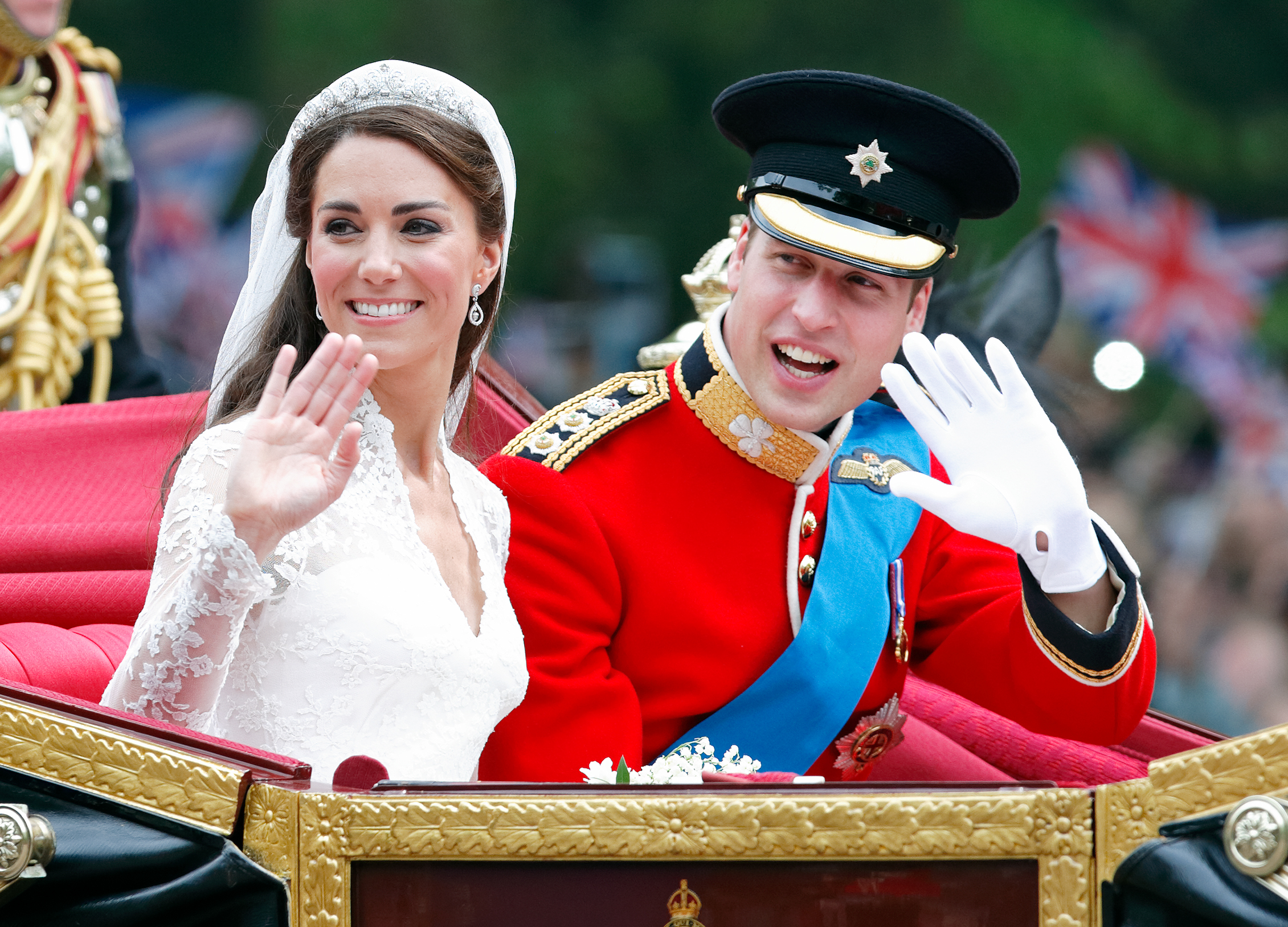 Prince William and Princess Kate waving from a carriage after their wedding