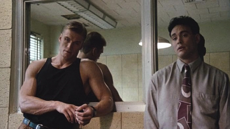 Chris Kenner (Dolph Lundgren) stands next to Johnny Murata in a police interrogation room in Showdown in Little Tokyo