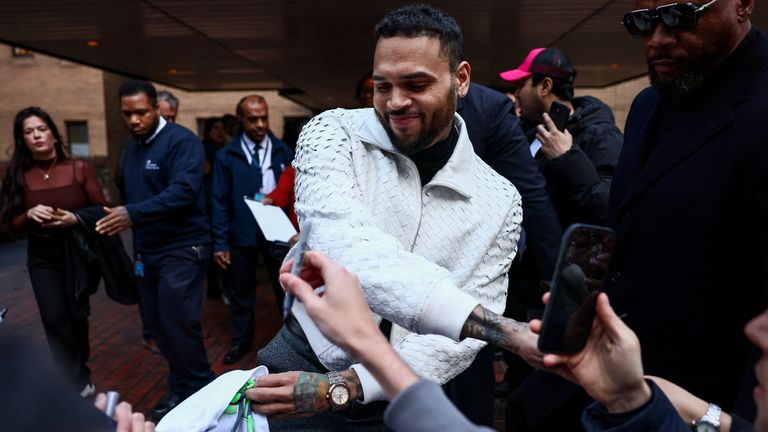 Brown greets fans outside the court building. Pic: Reuters