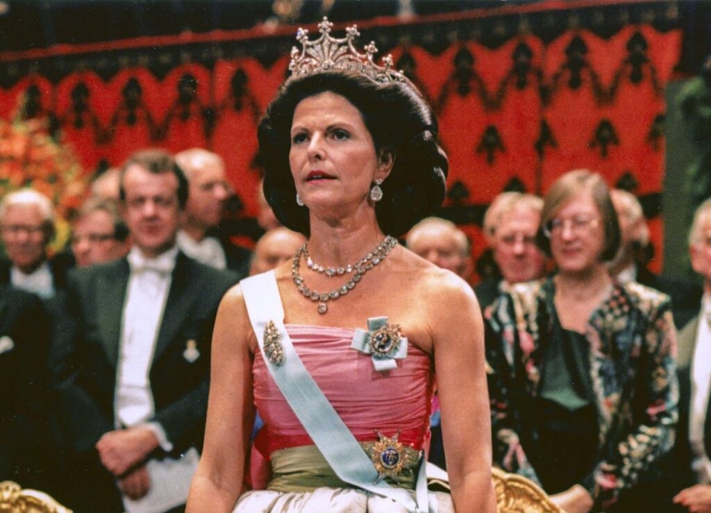 Did Queen Silvia of Sweden simply have super thick hair and thats how she was able to get such massive hair bun? Or was there something else going on? Like fake hair added on?