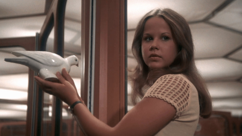 Regan holding a ceramic dove in 