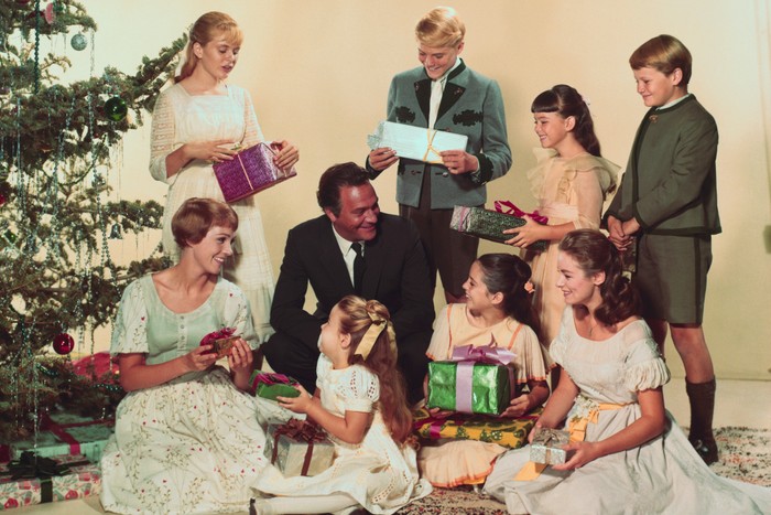 Cast of The Sound of Music Movie still from the 1965 film The Sound of Music showing Julie Andrews, Christopher Plummer and the Von Trapp children gathered to open presents by the Christmas tree.