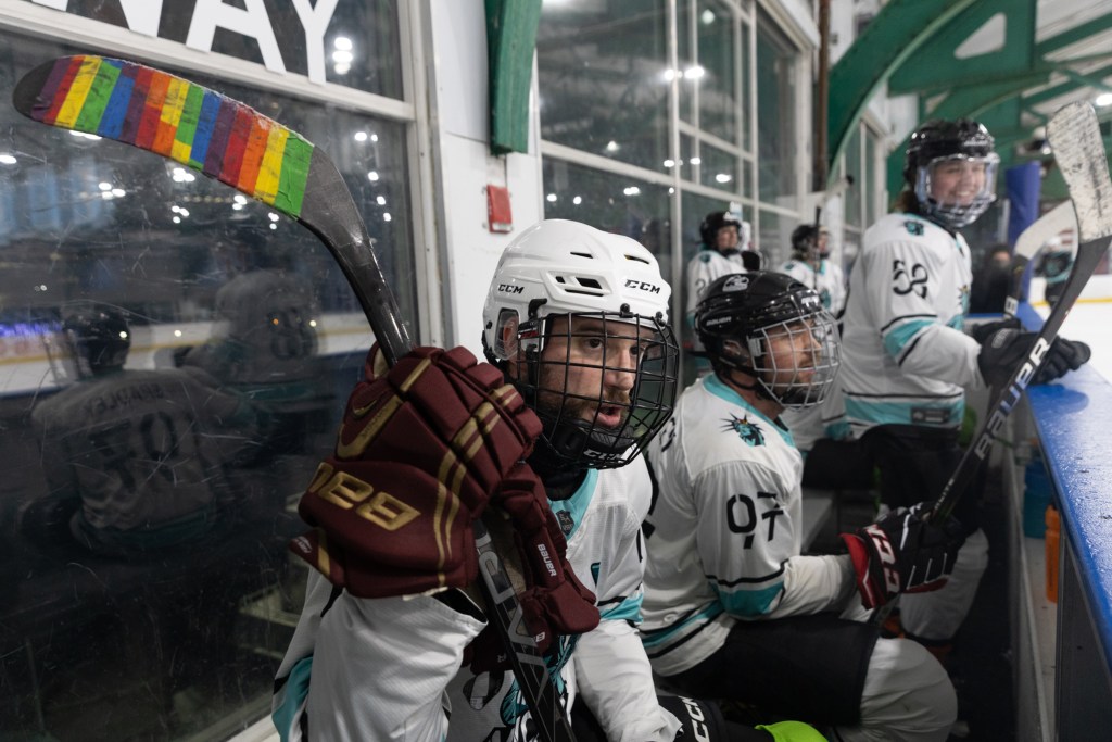 Pride Hockey Alliance members cheer on their teammates during a game at Chelsea Piers,