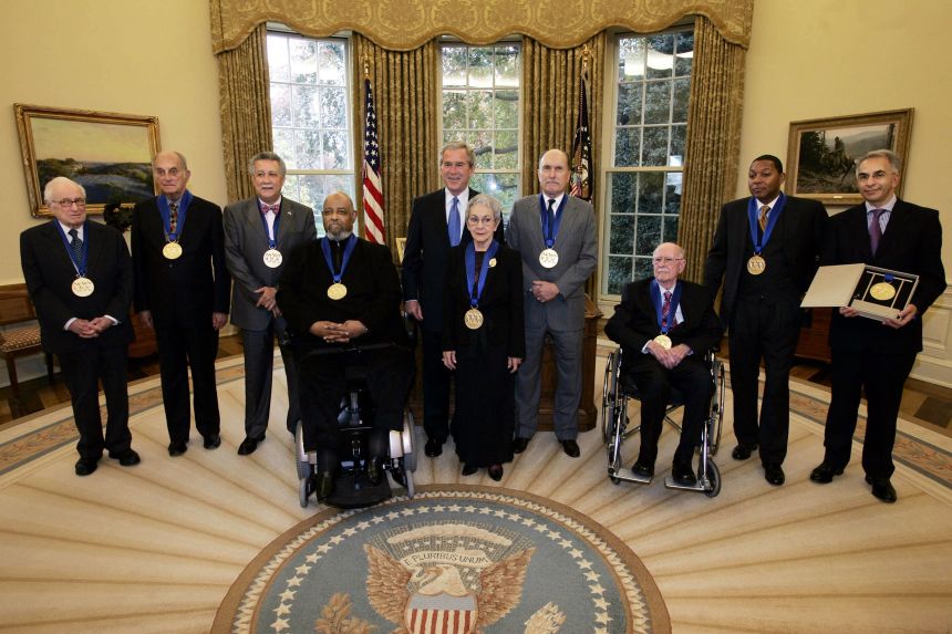 President Bush, center, stands with National Medal of Arts recipients, from left to right: Leonard Garment, Louis Auchincloss, Paquito DRivera, James DePreist, Tina Ramirez, Robert Duvall, Ollie Johnston, Wynton Marsalis and Derek Gillman, in the Oval Office on November 10, 2005.