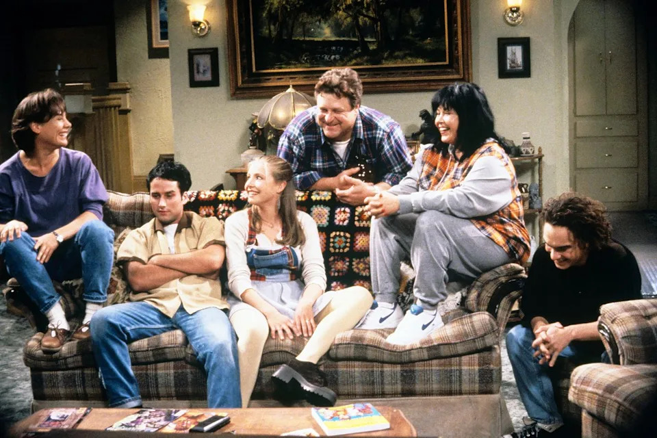 Laurie Metcalf (Jackie), Glenn Quinn (Mark), Sarah Chalke (Becky), John Goodman (Dan), Roseanne Barr (Roseanne), and Johnny Galecki (David) on 'Roseanne' (19940 ABC Photo Archives/Disney General Entertainment Content via Getty