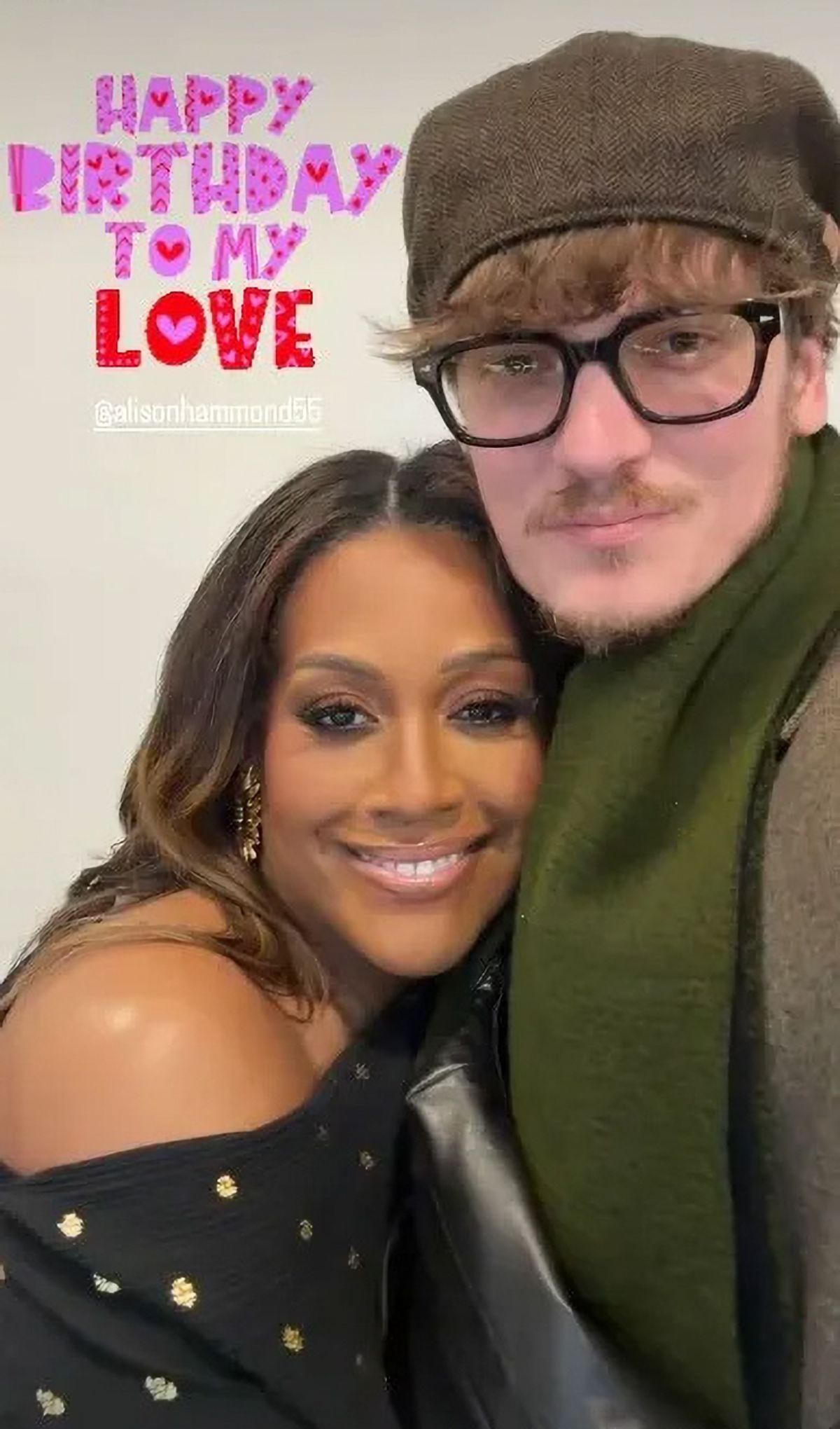 Alison Hammond smiling wildly while closely hugging David Putman, who gazes emotionlessly forwards