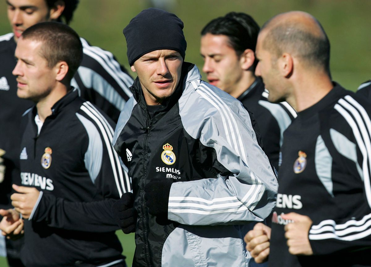 David Beckham (C) and Michael Owen (L) warm up beside Zinedine Zidane (R) of France during a club training session on November 12, 2004 in Las Rozas Madrid, Spain