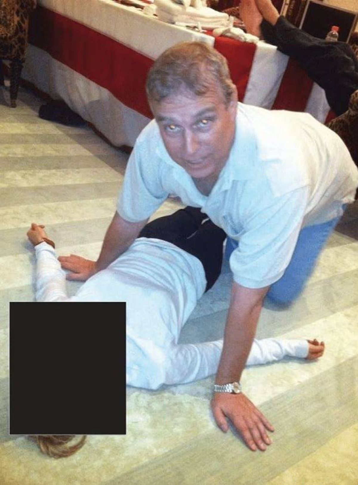 Disturbing photos released in the Epstein files appear to show Andrew Mountbatten-Windsor crouching on all fours over a female lying on the floor.