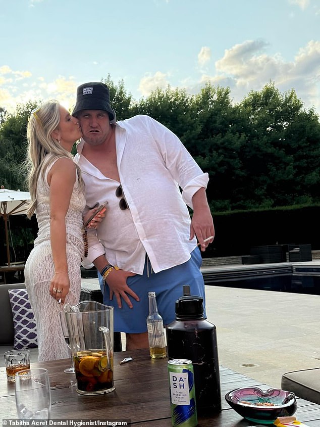 Elsewhere they were larking around while having a cigarette in a garden in front of an outdoor pool, as Tabitha leaned in to give him a kiss on the cheek