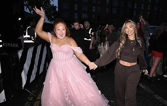 'Lacey.m.xxx' holds hands with influencer and cosmetics guru Paige Louise Williams, who provided goodie bags stuffed with P.Louise products at the event