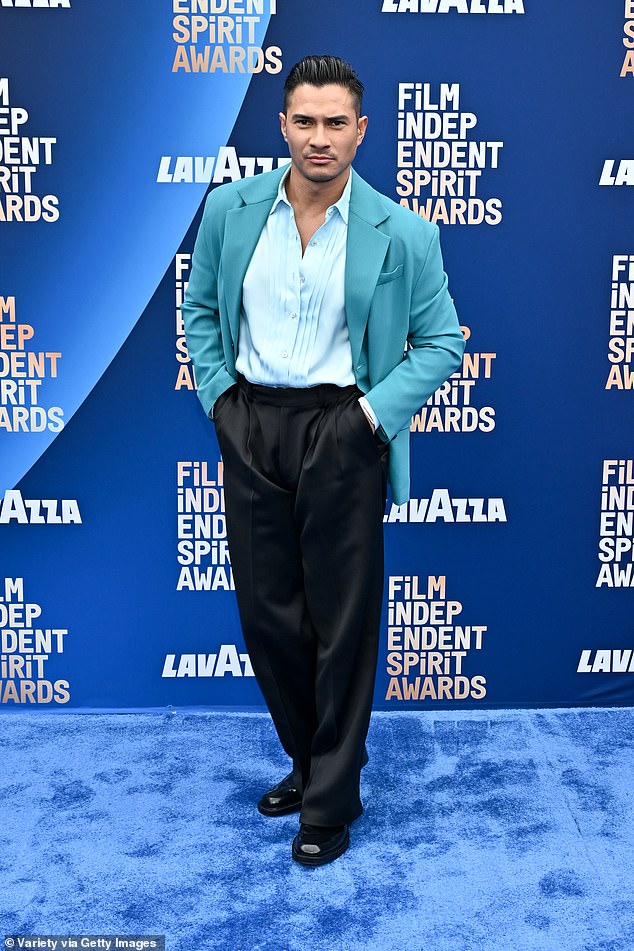 Brandon Finn showed off his style in an aquamarine blazer paired with a baby blue button up and black silk pants