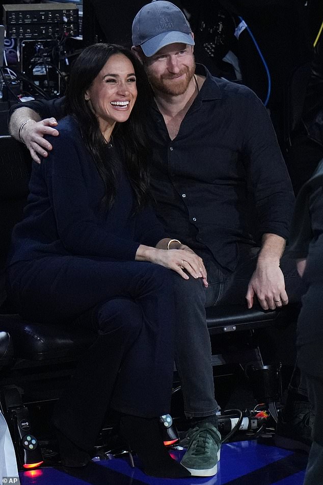 Meghan tucked herself into her husband's sided as they beamed for the NBA media