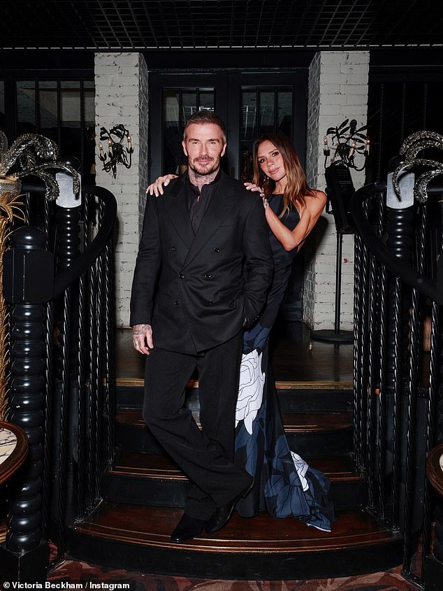 Fashion mogul Victoria stunned in a navy halterneck gown while husband David cut a dapper figure in a coordinated suit