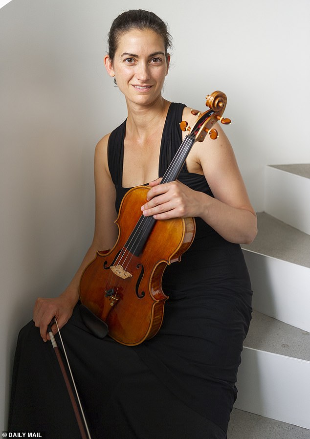 Ms Meron (pictured with her instrument in 2019) performed with top orchestras in venues across the world before her accident, which left her unable to play as she suffers from long-term damage to two nerves in her left arm and cannot separate two fingers on her left hand