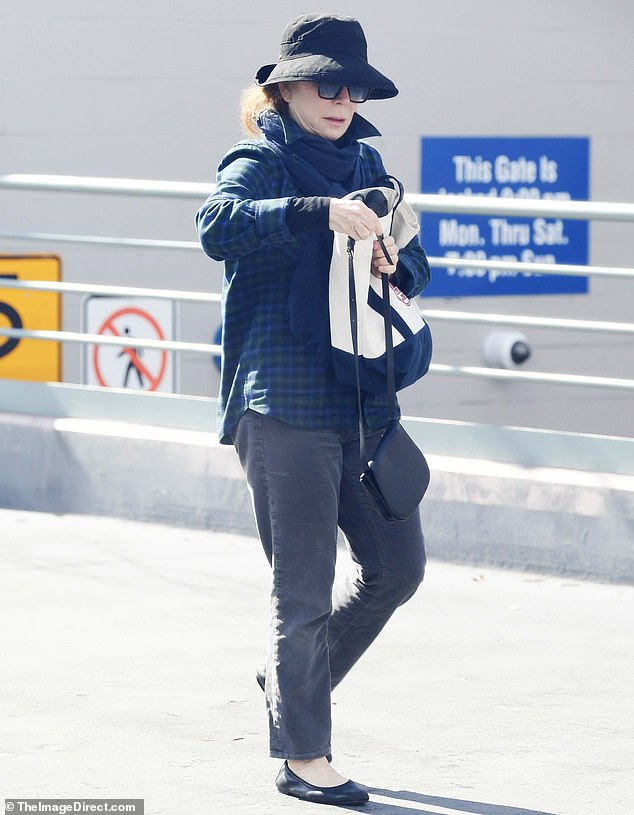 She cut a stylish figure when she surfaced this week in a flowing plaid top and grey jeans accessorized with shades, a jaunty slouched-brim hat and a deep blue scarf