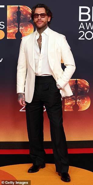 Pete Wicks looked dapper in a white blazer and teased a glimpse of his many tattoos by wearing his white shirt partially undone