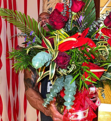 Dwayne Johnson holds up a bouquet of flowers he received from his family for Valentine's Day 2021 Dwayne Johnson/Instagram