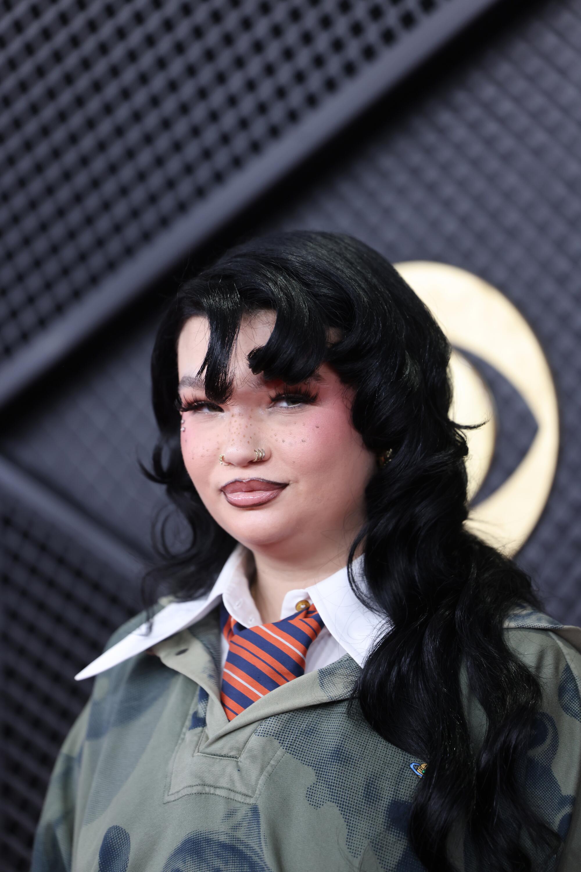 Lola Young poses on the red carpet. 