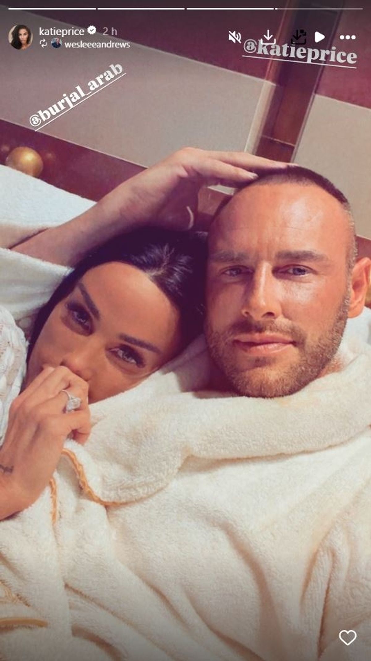 Katie Price and Lee Andrews wearing dressing gowns and snuggled up together
