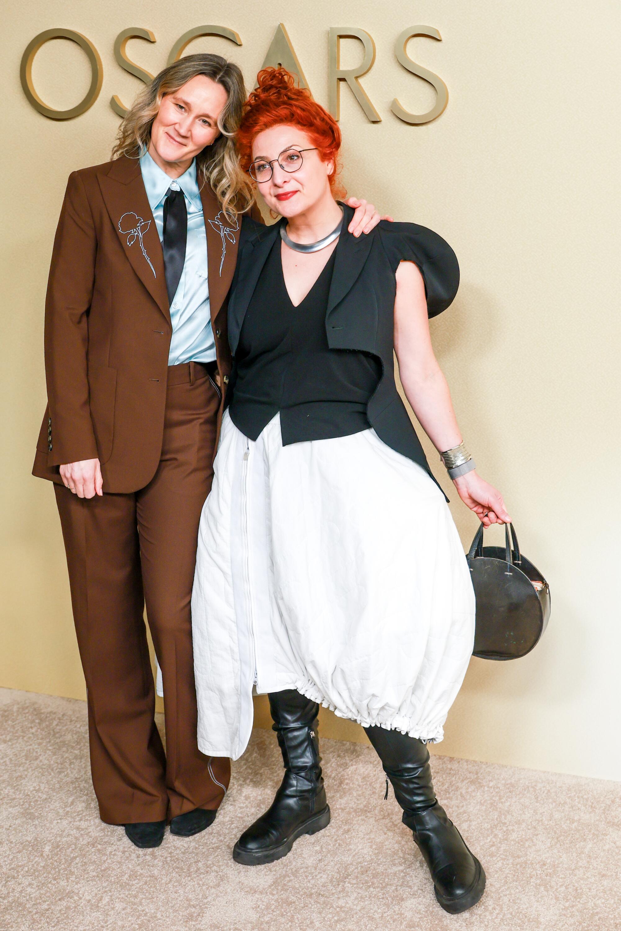 Alice Felton and Malgosia Turzanska hug on the beige carpet. 