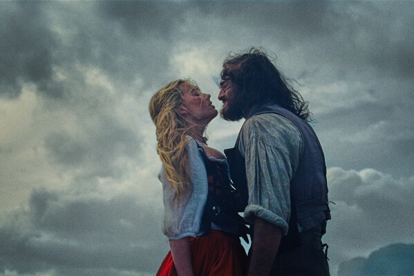 This image released by Warner Bros. Pictures shows Margot Robbie, left, and Jacob Elordi in a scene from "Wuthering Heights." (Warner Bros. Pictures via AP)