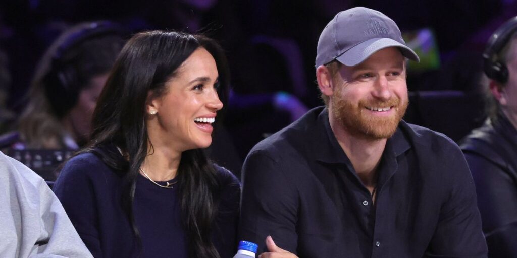 Prince Harry makes gesture to UK during new public appearance alongside Meghan Markle Prince Harry makes gesture to UK during new public appearance alongside Meghan Markle