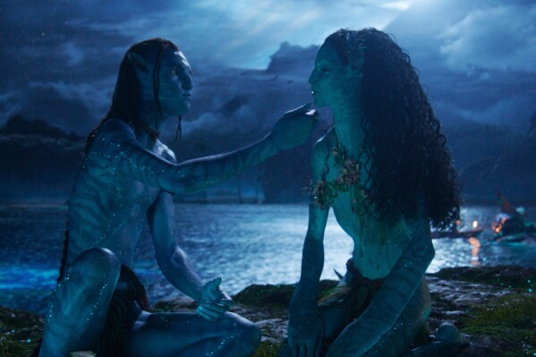 This image released by Disney shows Lo'ak, performed by Britain Dalton, left, and Tsireya, performed by Bailey Bass in a scene from "Avatar: Fire and Ash." (20th Century Studios/Disney via AP)