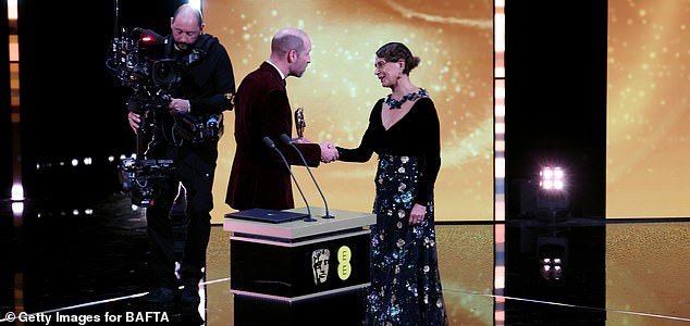 LONDON, ENGLAND - FEBRUARY 22: Prince William, Prince of Wales presents the Fellowship Award to Dame Donna Langley on stage during the EE BAFTA Film Awards 2026 at The Royal Festival Hall on February 22, 2026 in London, England. (Photo by Tristan Fewings/BAFTA/Getty Images for BAFTA)