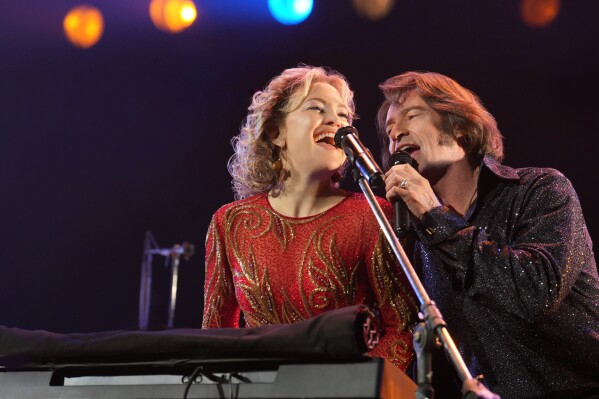 This image released by Focus Features shows Kate Hudson, left, and Hugh Jackman in a scene from "Song Sung Blue." (Sarah Shatz/Focus Features via AP)