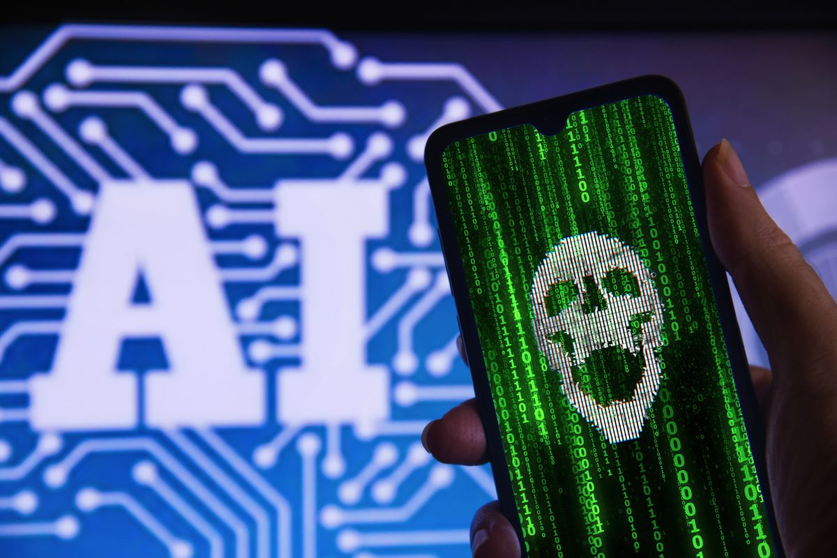 Hand holding a hacked cell phone with a skull (cyber attack), with the Artificial Intelligence (AI) symbol in the background.