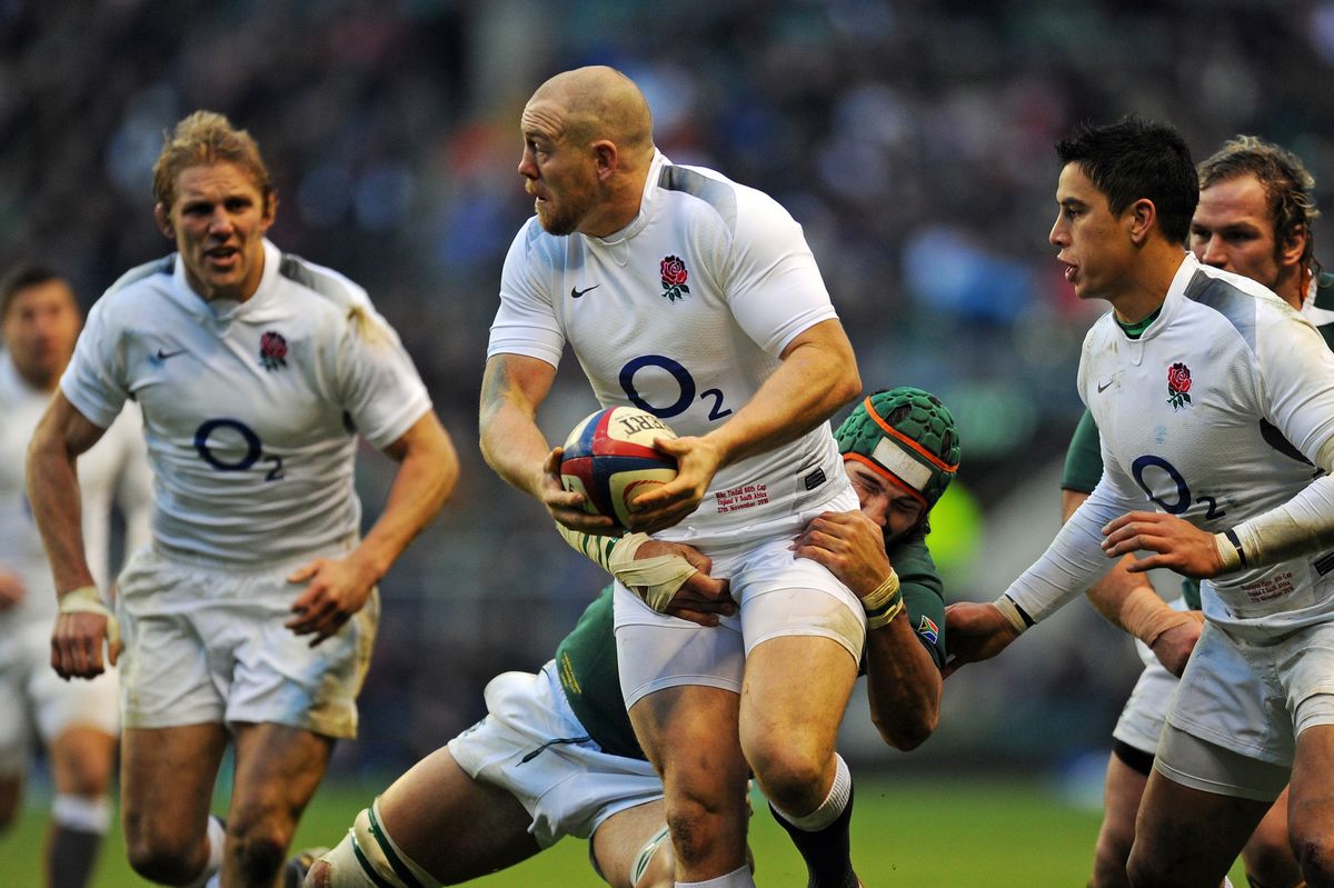 England centre Mike Tindall (2nd L) is tackled by South Africa's captain Victor Matfield (3rd R) during the Autumn International rugby union match between England and South Africa
