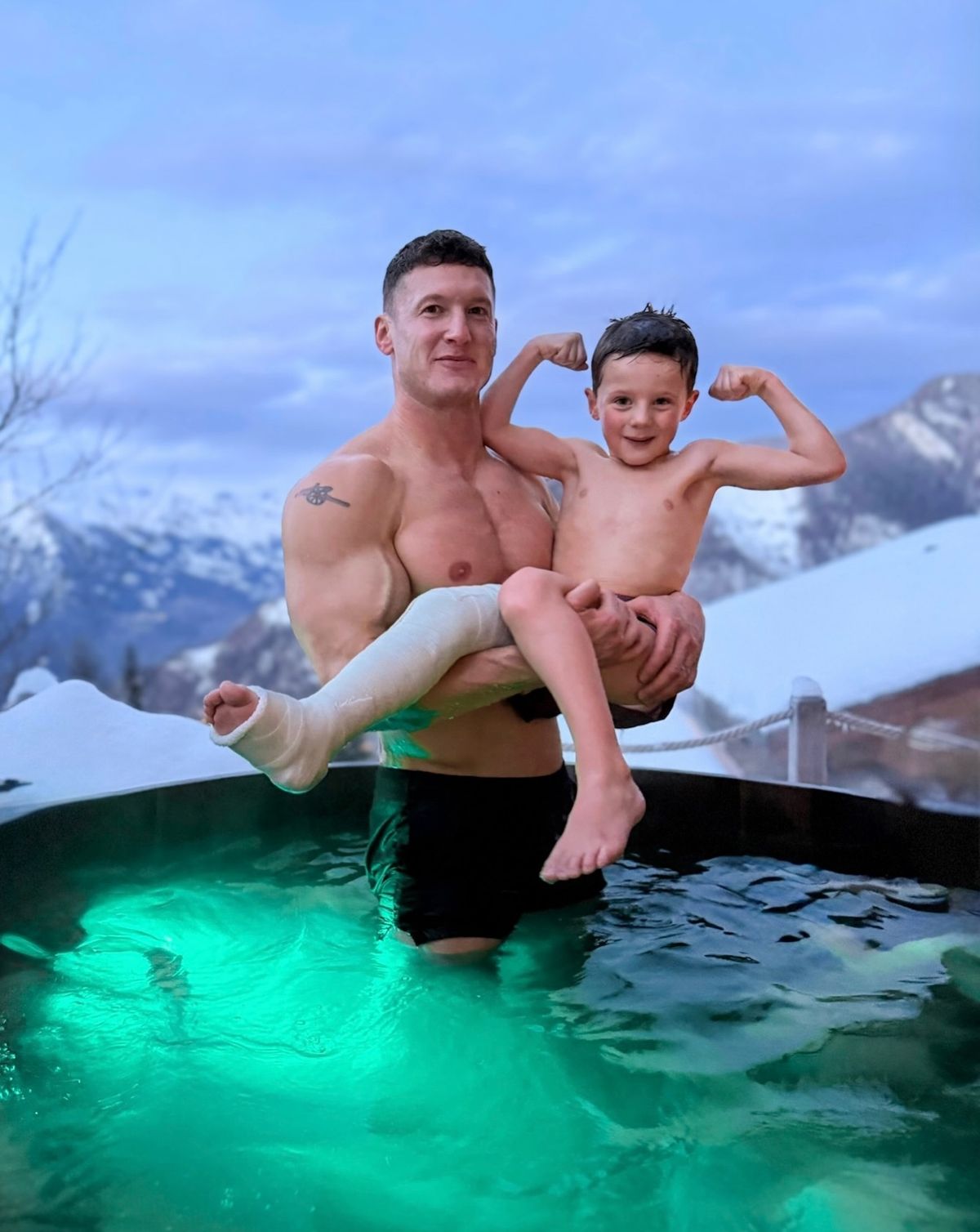 Matt Morsia holding his son, Mauro, in a hot tub