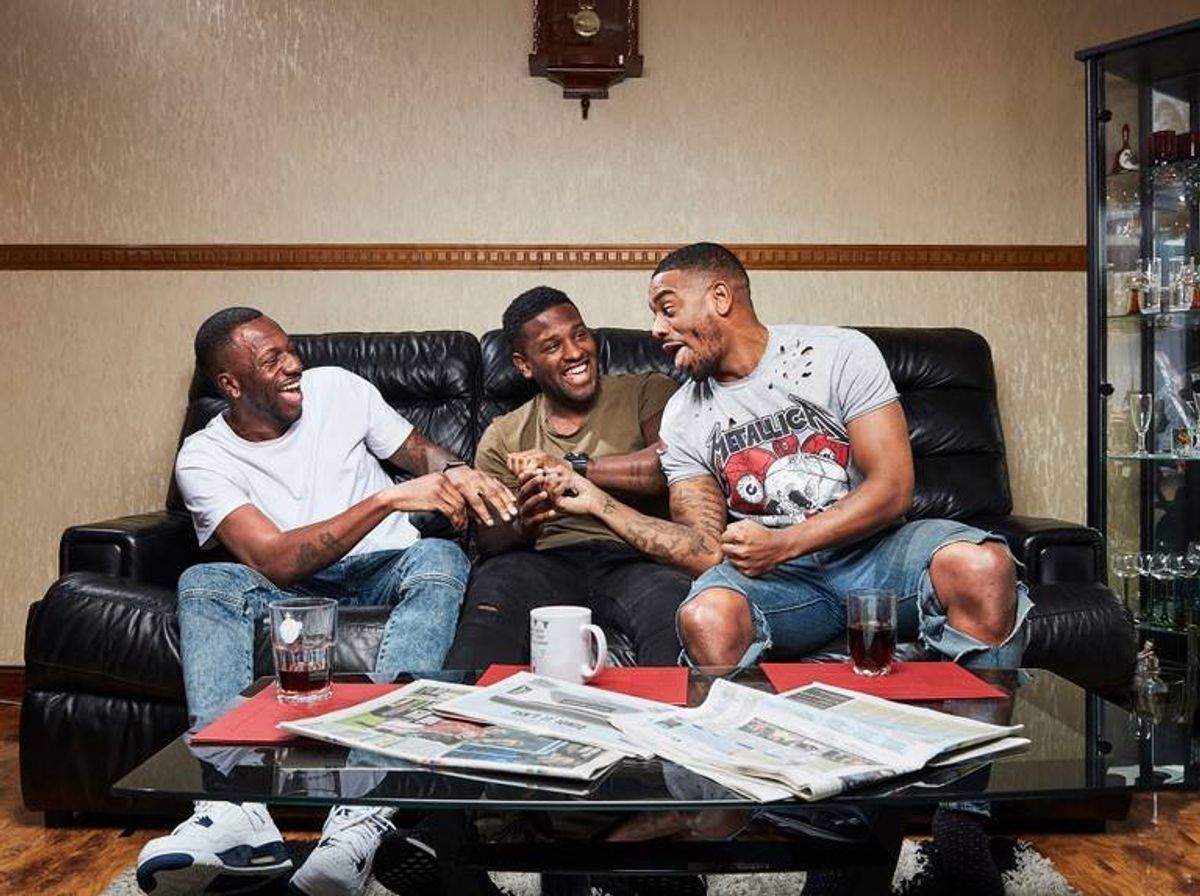 The brothers joking around while sitting on couch 