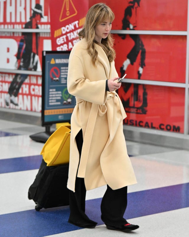 Woman walking in an airport terminal.